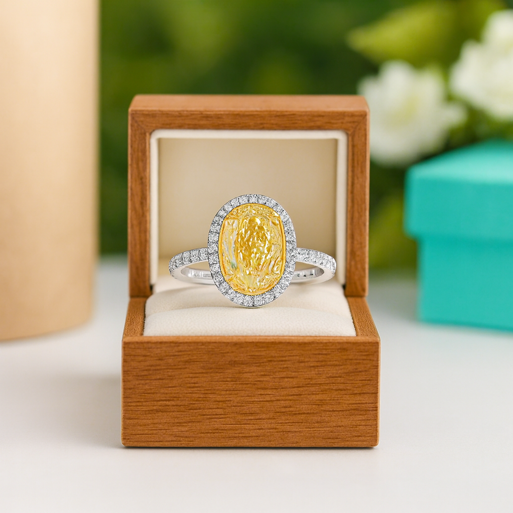 Gold and silver ring in a wooden box with a blurred floral background