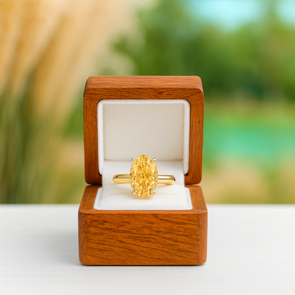 Gold ring in a wooden box with a blurred natural background