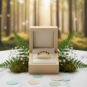 Gold ring in a wooden box with a forest background