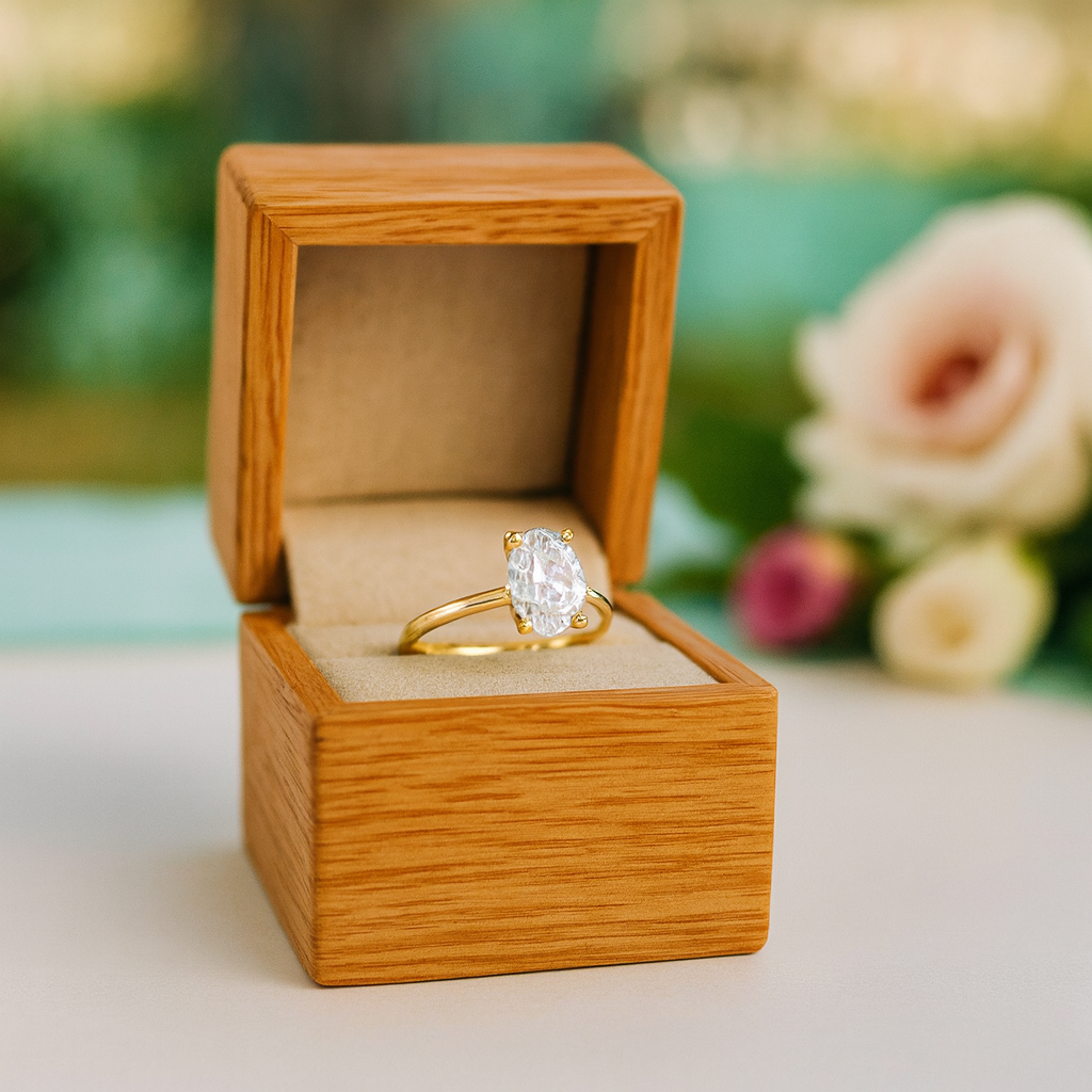 Gold ring in a wooden box with flowers in the background
