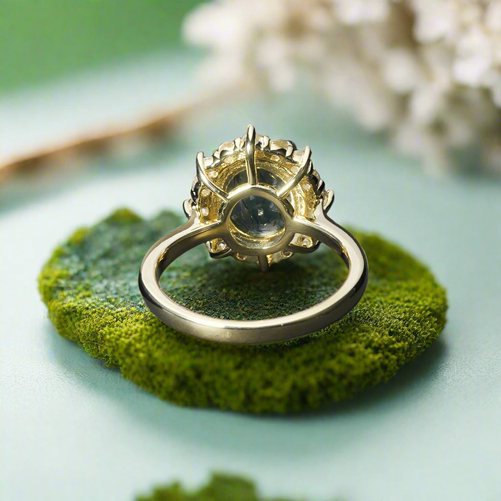 Gold ring with a central gemstone on a dark fabric background