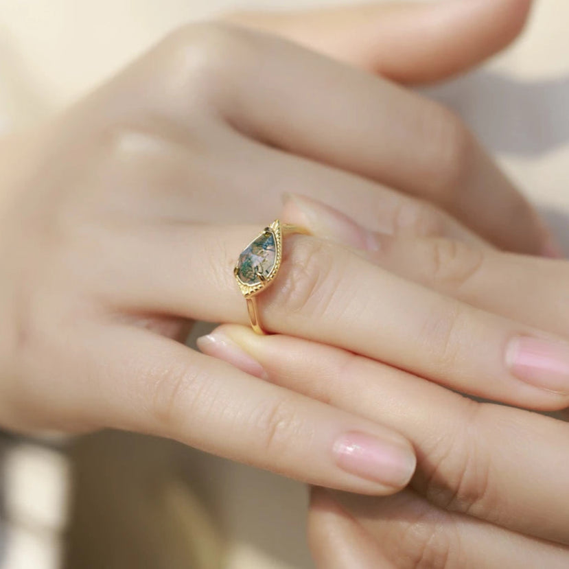 Gold ring with a gemstone on a hand