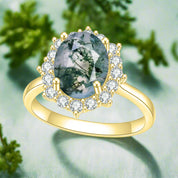 Gold ring with a green gemstone and diamond accents on a white background