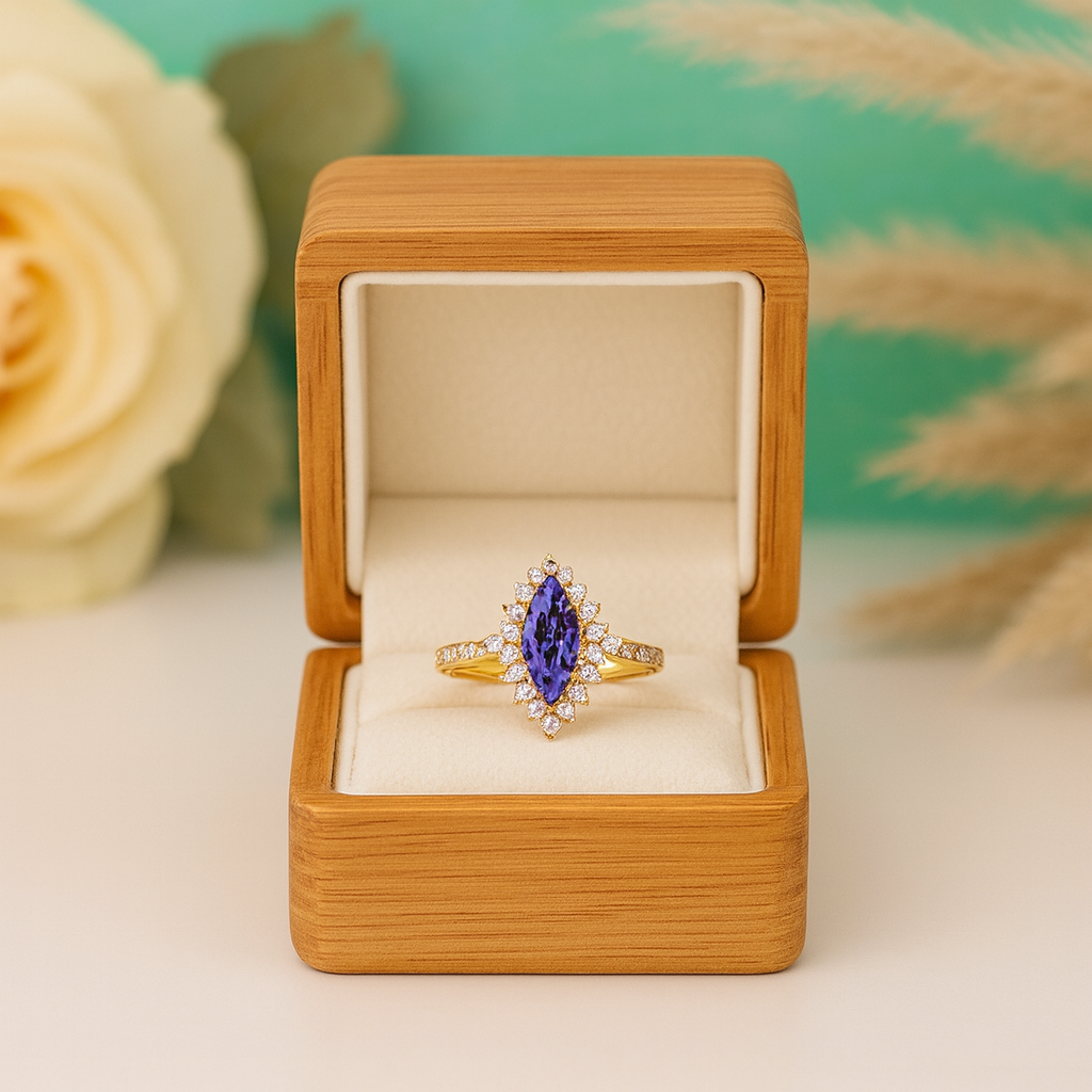 Gold ring with a purple gemstone in a wooden box against a floral background