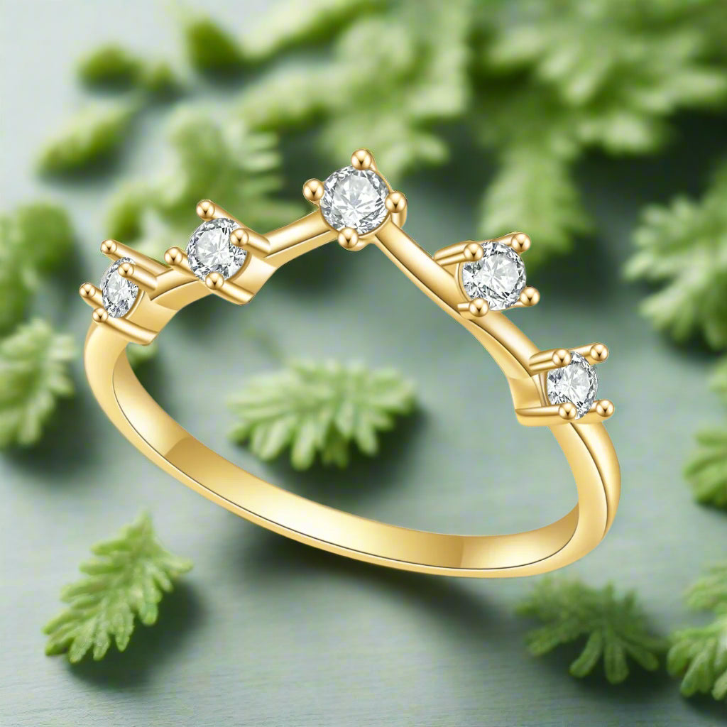 Gold ring with diamond accents on a white background