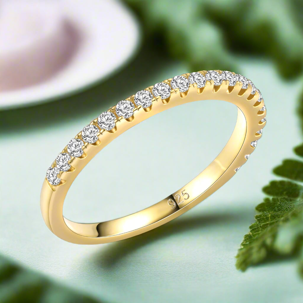Gold ring with diamonds on a white background