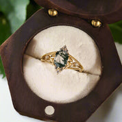 Gold ring with gemstone in a wooden jewelry box