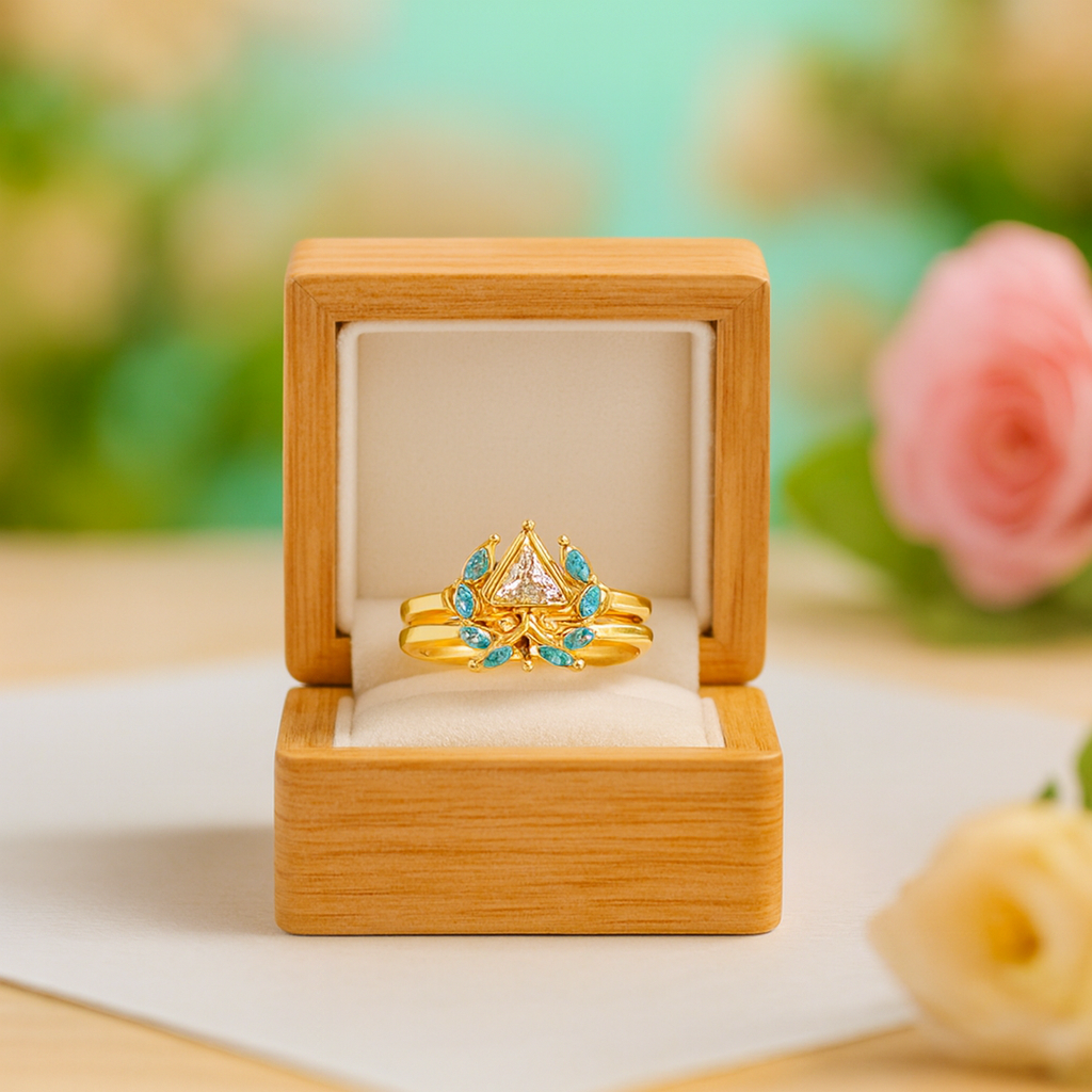 Gold ring with gemstones in a wooden box on a blurred floral background