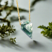 Green crystal pendant on a gold chain 