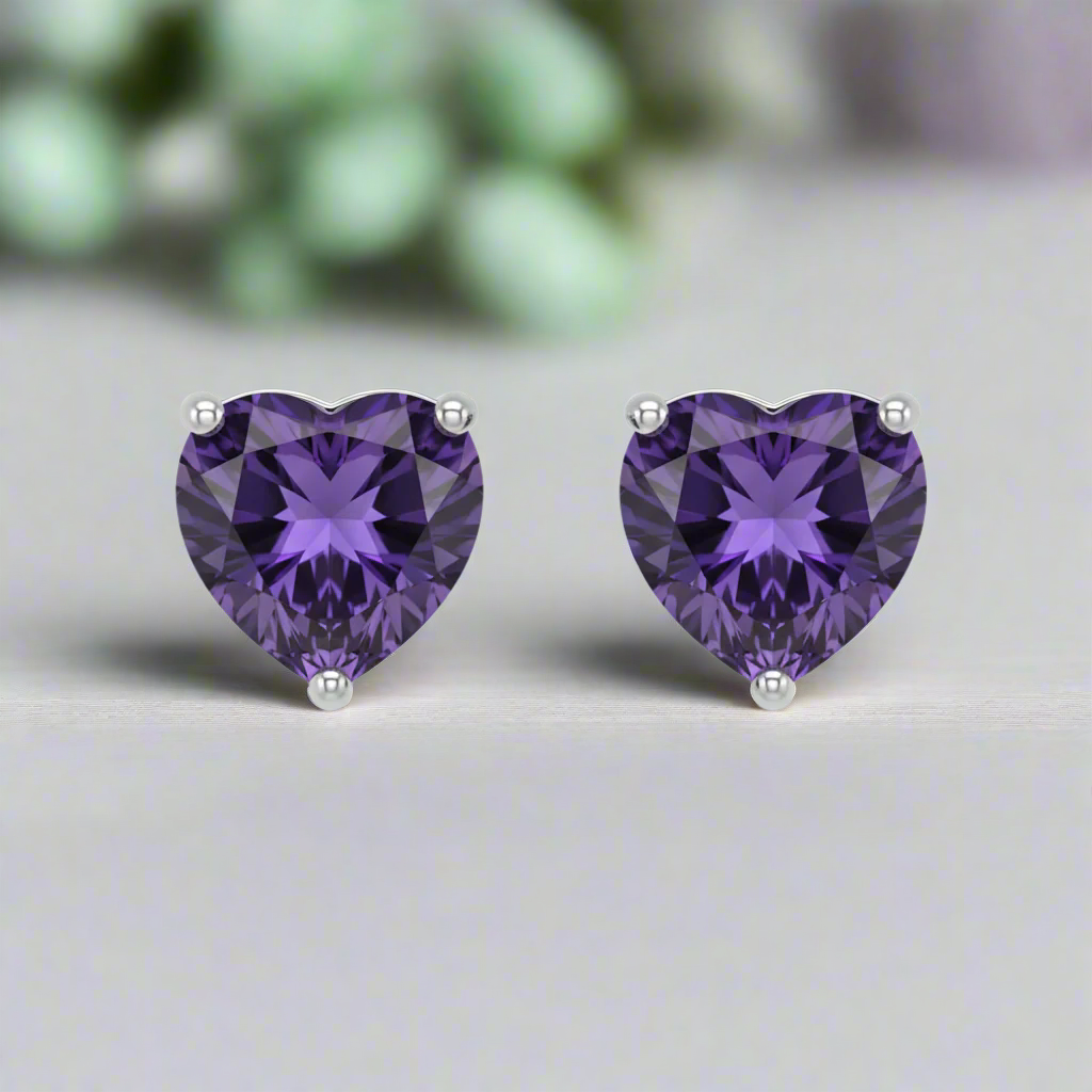 Heart-shaped purple gemstone earrings on a white background