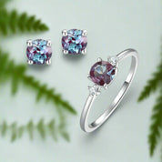 Jewelry set with ring and earrings featuring multicolored gemstones on a white background