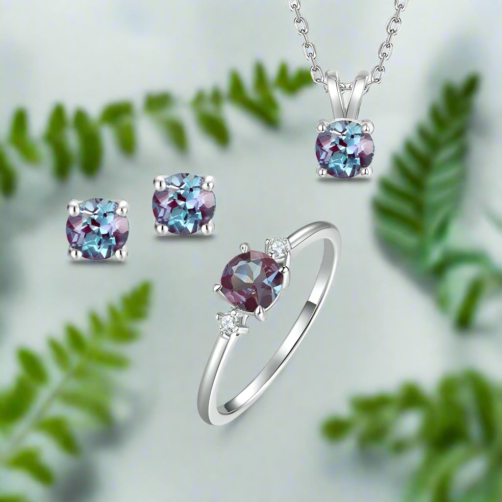 Jewelry set with ring, earrings, and necklace featuring purple gemstones on a white background