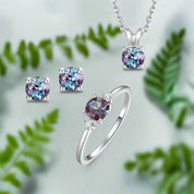 Jewelry set with ring, earrings, and necklace featuring purple gemstones on a white background