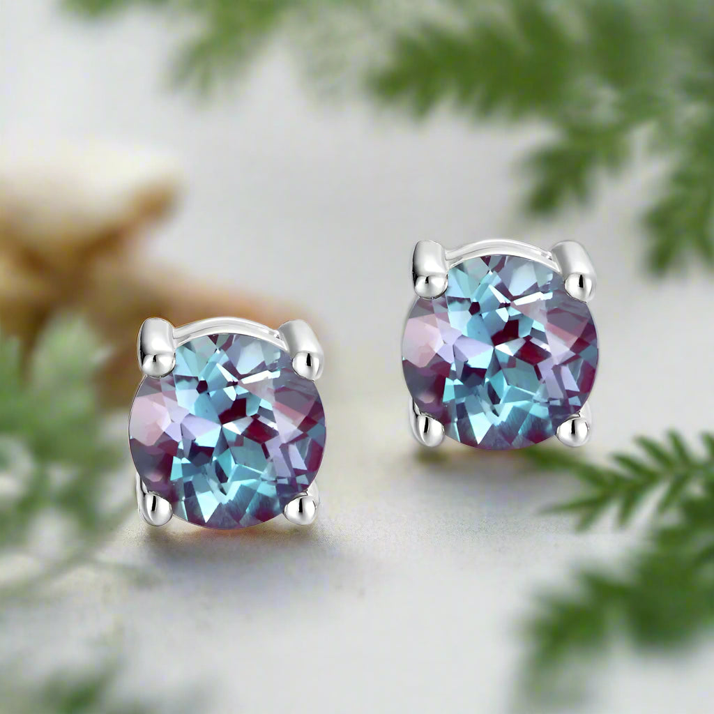 Multicolored gemstone stud earrings on a white background