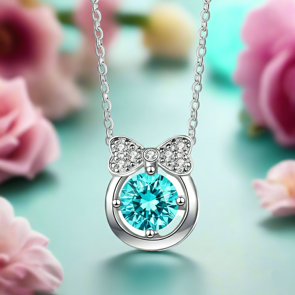Necklace with a blue gem and bow design against a floral background