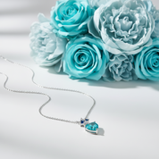 Necklace with a blue heart-shaped gemstone pendant on a white background