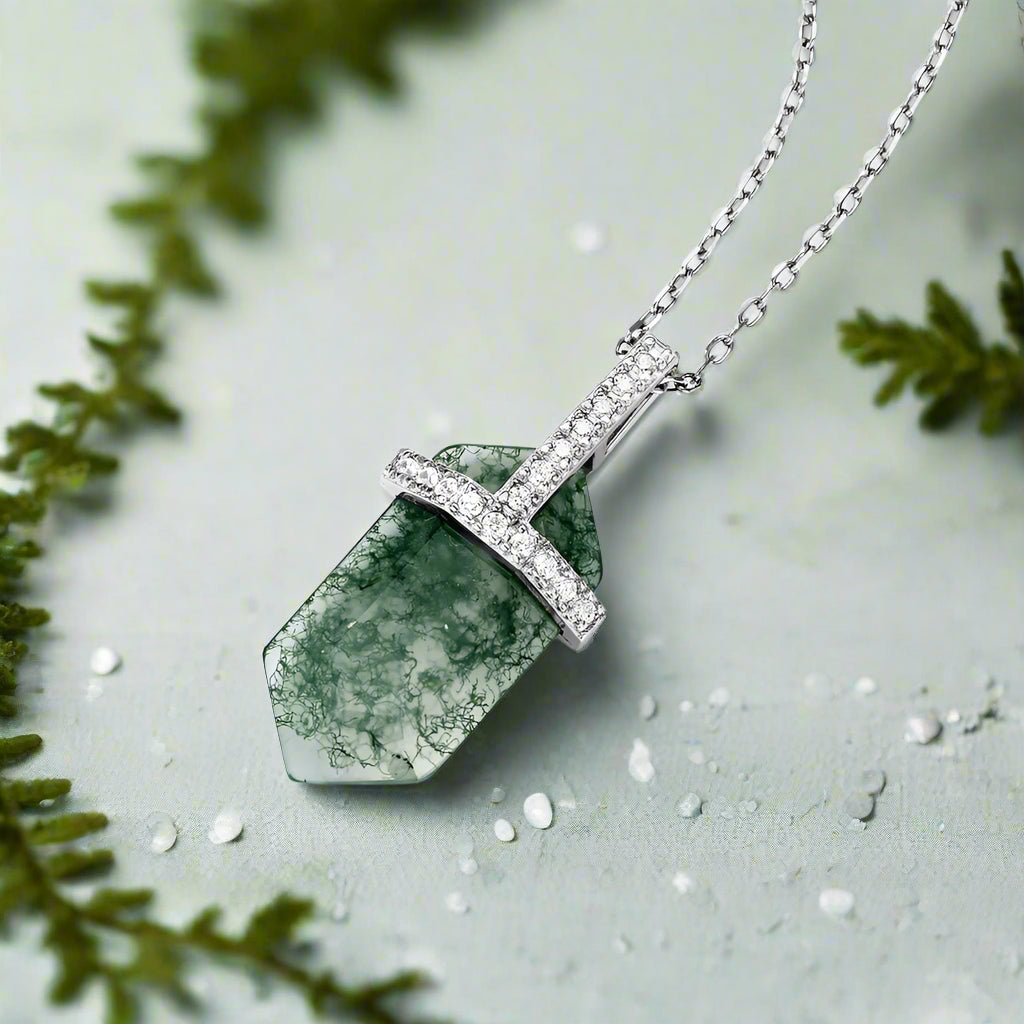 Necklace with a green stone pendant on a white background