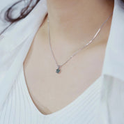 Necklace with a pendant worn by a person