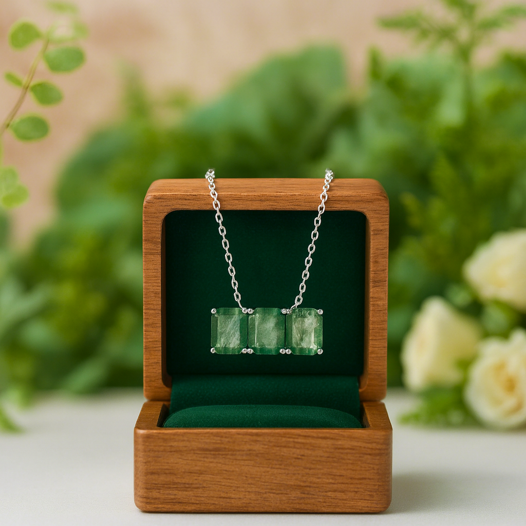 Necklace with green gemstones in a wooden box against a natural background