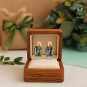 Pair of earrings in a wooden box with a decorative background