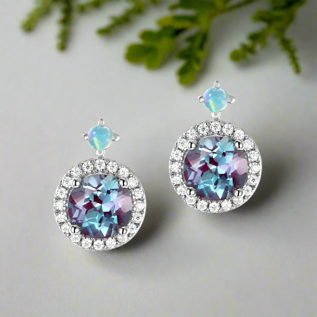 Pair of earrings with multicolored gemstones on a white background