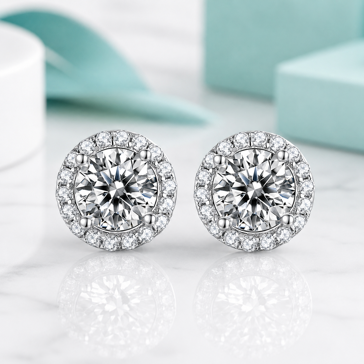 Pair of silver earrings with clear gemstones on a light background