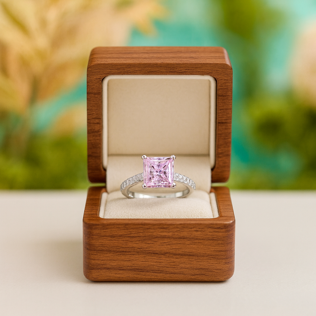 Pink diamond ring in a wooden box with a blurred natural background