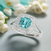 Ring with a blue gemstone and diamond-studded band on a light background