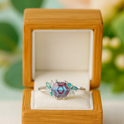 Ring with a hexagonal gemstone in a wooden box on a light background
