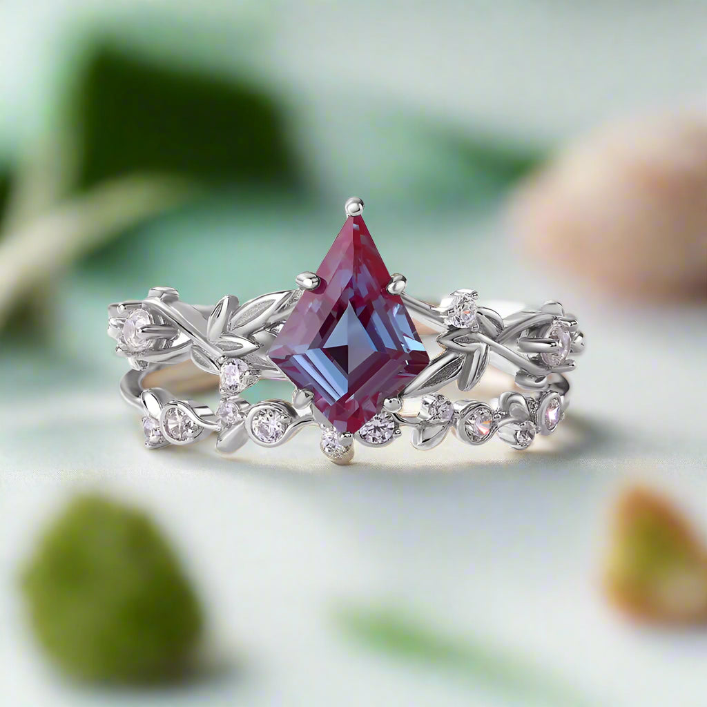 Ring with a large purple gemstone and smaller diamonds on a light gray background
