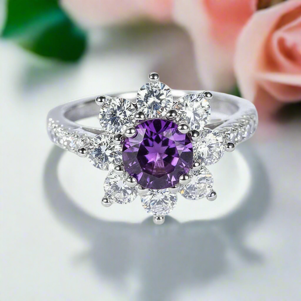 Ring with a purple gemstone and diamond-like stones on a white background