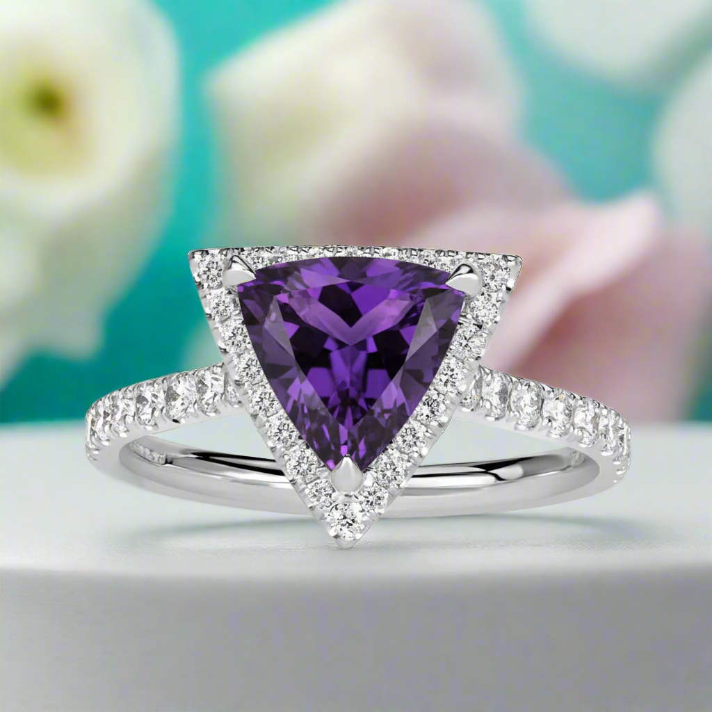 Ring with a purple gemstone and diamond accents on a white background