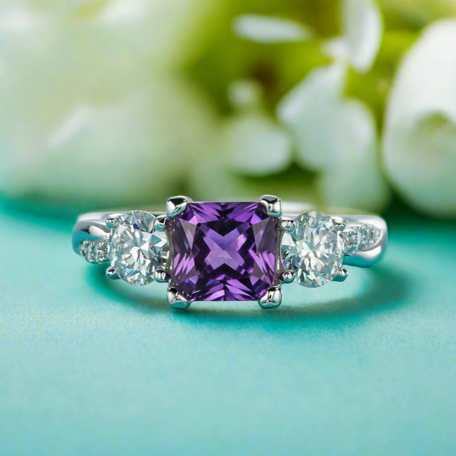 Ring with purple gemstone and diamonds on a blurred floral background