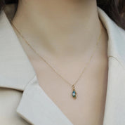 Necklace with a pendant on a mannequin wearing a white coat