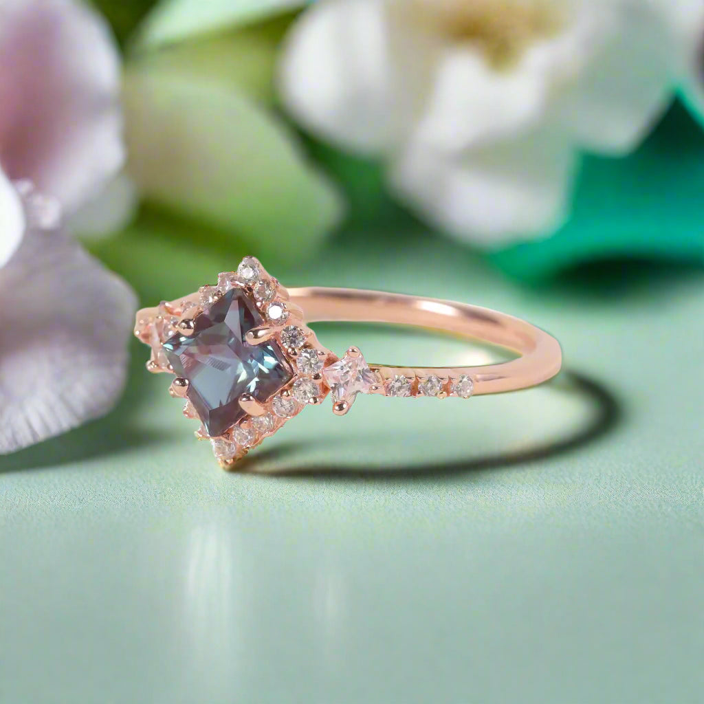 Rose gold ring with a blue gemstone on a light background