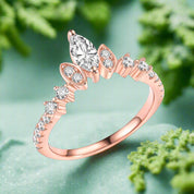 Rose gold ring with diamond accents on a white background