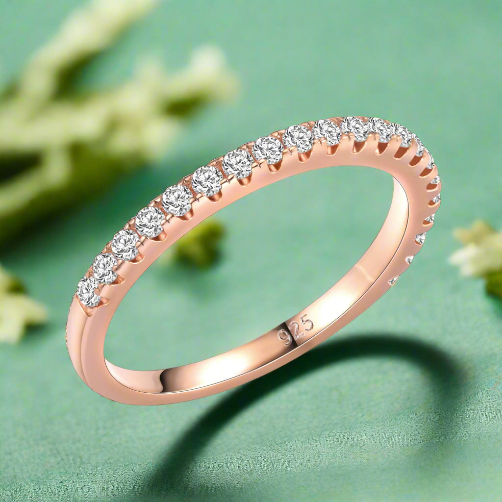 Rose gold ring with diamonds on a white background