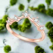 Rose gold ring with diamonds on a white background