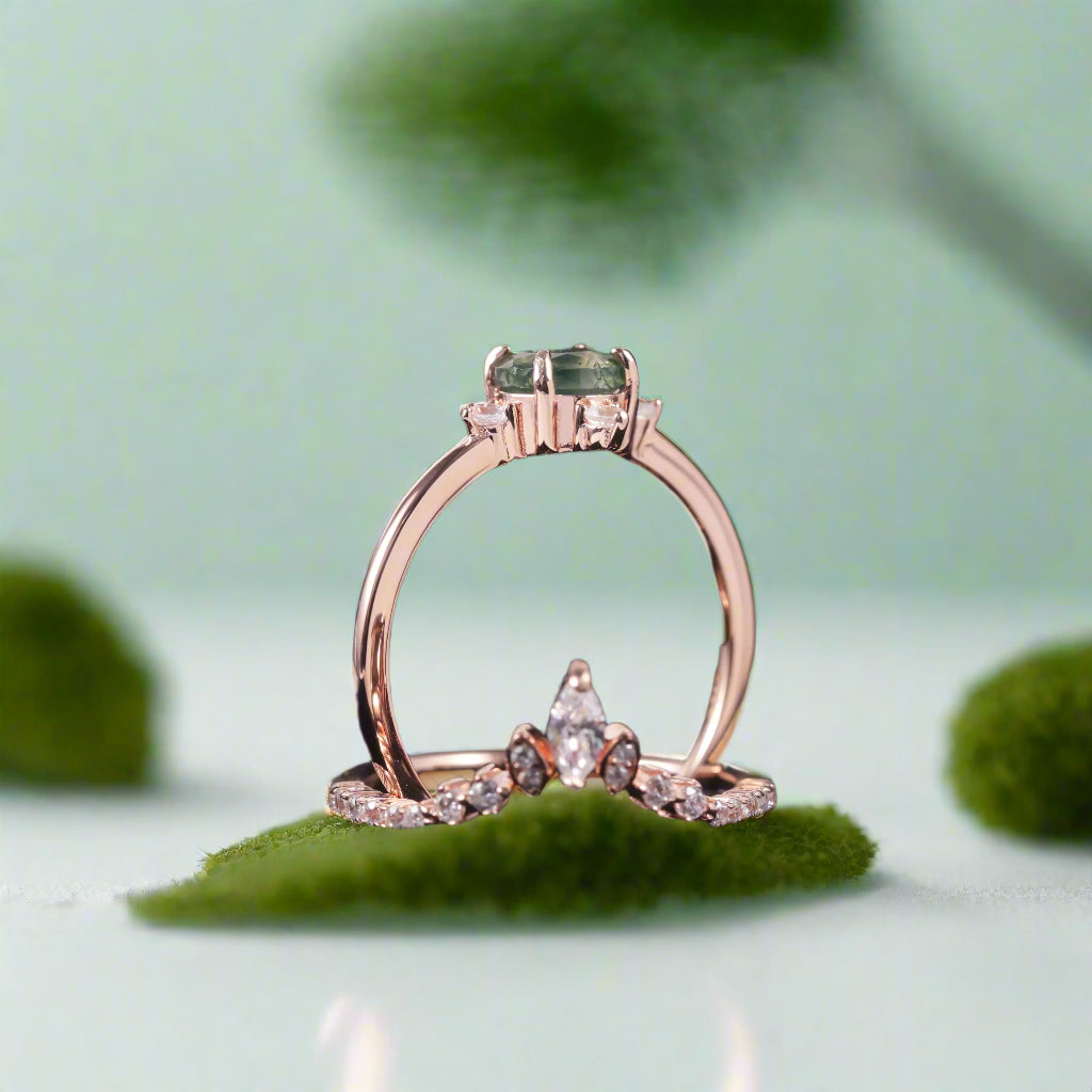 Rose gold ring with green gemstone on a dark background