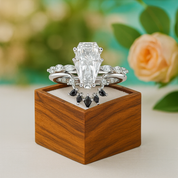 Set of diamond rings on a wooden box with a blurred floral background