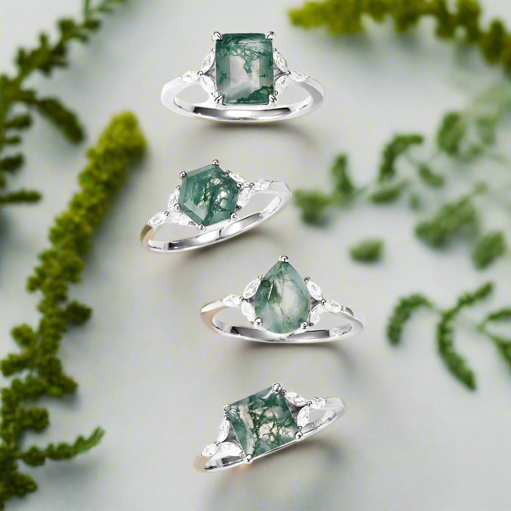 Set of four green gemstone rings on a white background 