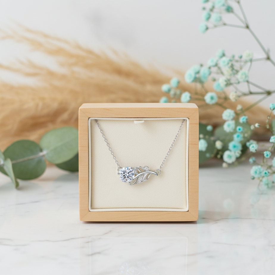 Silver necklace in a wooden box with decorative elements on a light background