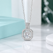 Silver necklace with a diamond pendant on a light background
