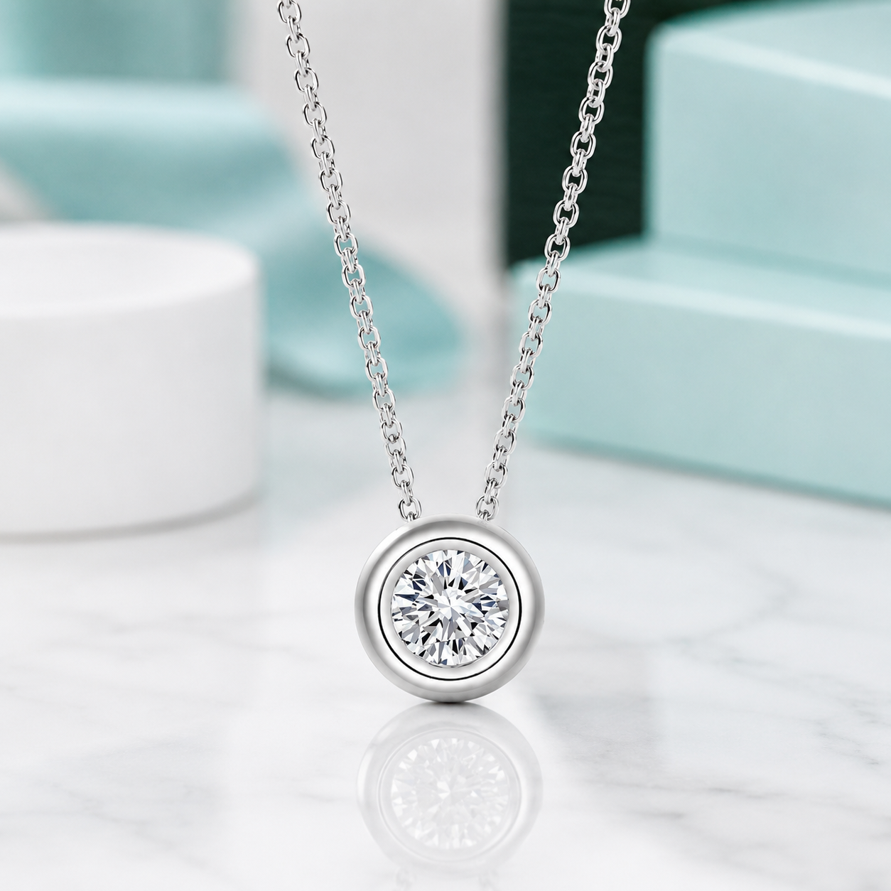 Silver necklace with a diamond pendant on a reflective surface
