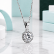 Silver necklace with a round diamond pendant on a light background