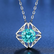 Silver necklace with a turquoise gemstone pendant on a blue background