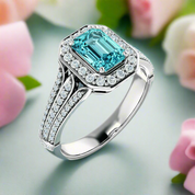 Silver ring with a blue gemstone and diamond accents on a white background