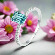 Silver ring with a blue gemstone on a white background