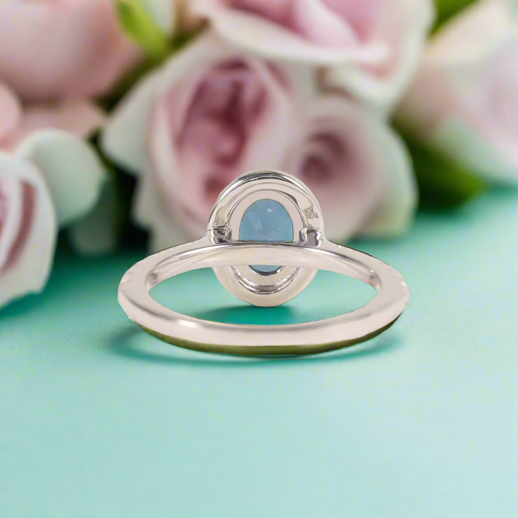 Silver ring with a blue gemstone on a white background
