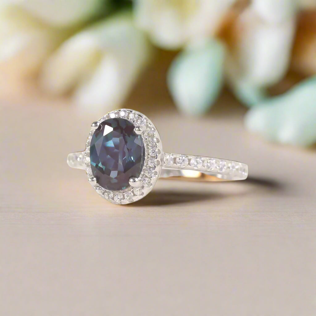 Silver ring with a blue gemstone on a white background